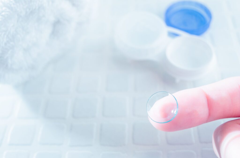 A close-up image of someone cleaning their contact lens to prevent buildup that can cause the lens to feel stuck in their eye.