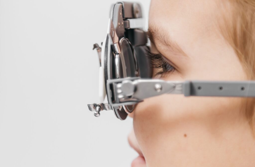 A close up of a child during a routine eye exam, measuring visual acuity.