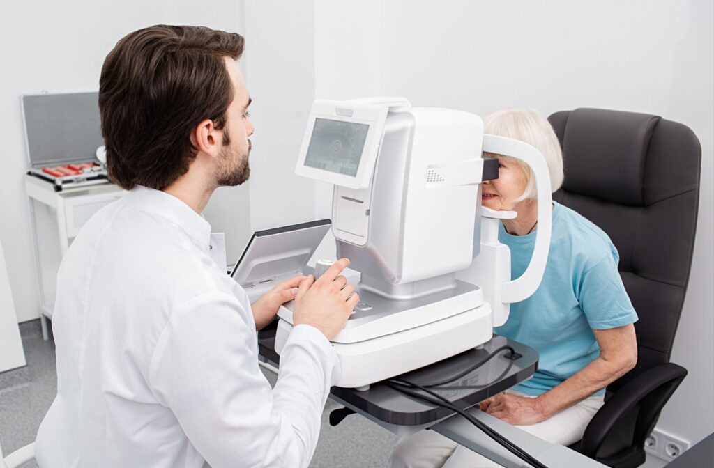 An optometrist performs a routine eye exam on a senior.