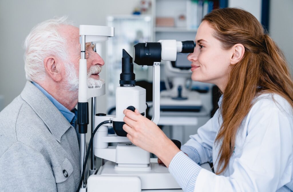 An optometrist examines a senior patient’s eyes for high eye pressure and other health issues to care for during an exam