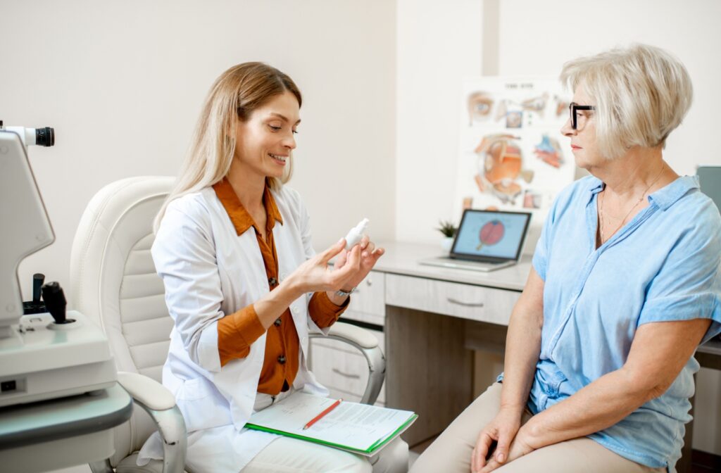 An optometrist discusses proper eye drop handling with a patient.
