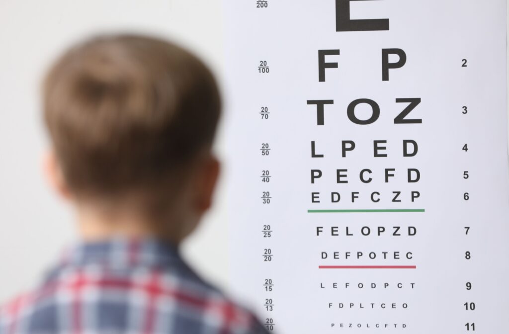 Child reading a Snellen eye chart.