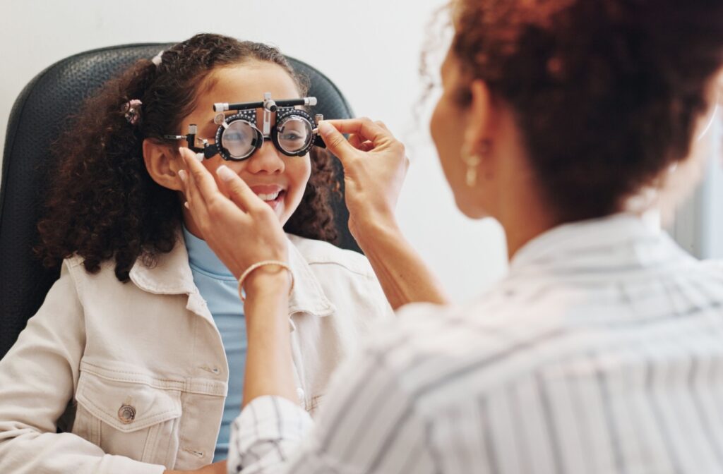 A child having their eyes tested for myopia during a comprehensive eye exam.